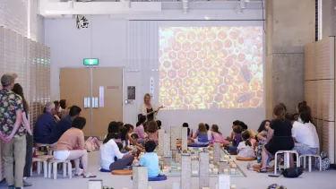 Children building models of their wildest city in an interactive workshop.